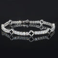 Gabrion white gold plated 925 sterling silver tennis bracelet with VVS moissanite stones and clover charms.