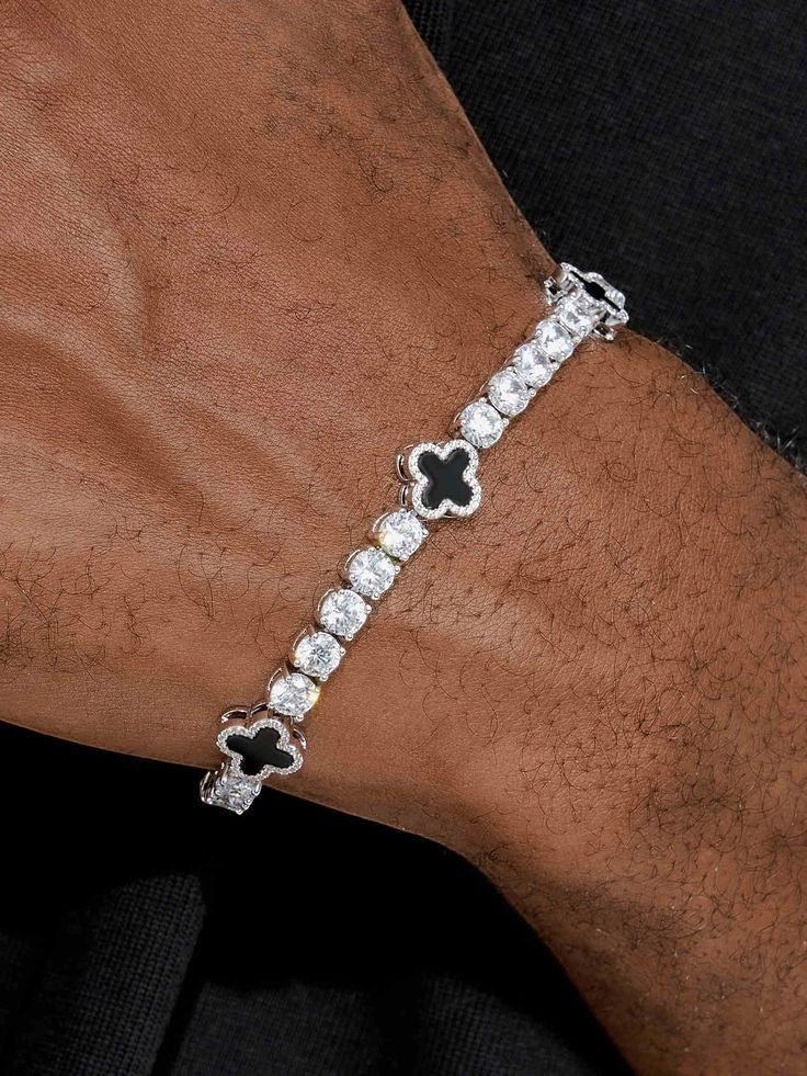 Gabrion 925 sterling silver tennis bracelet with VVS moissanite stones and black clover charms, plated with white gold.